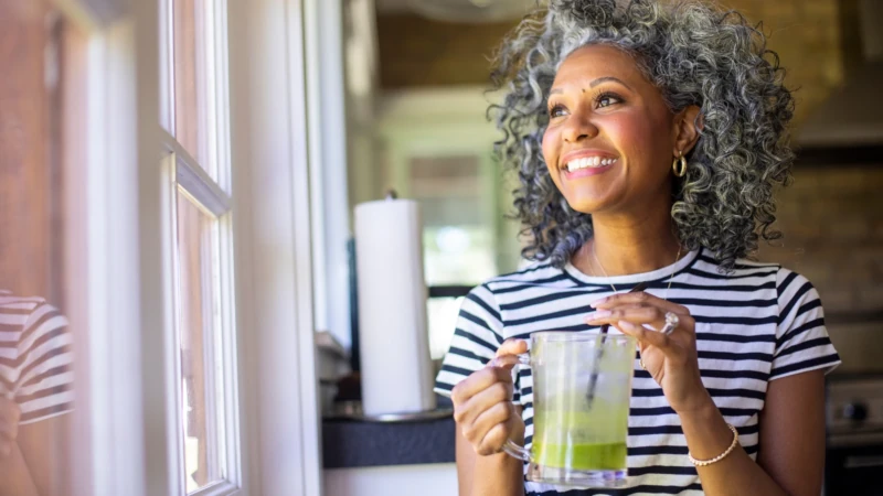 Lady enjoying a green health drink made from Project Biotech Smart Superfood